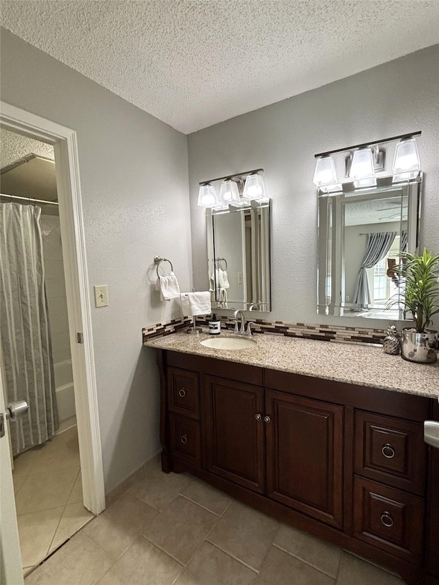 bathroom with shower / bath combo with shower curtain, a textured ceiling, vanity, and tile patterned floors