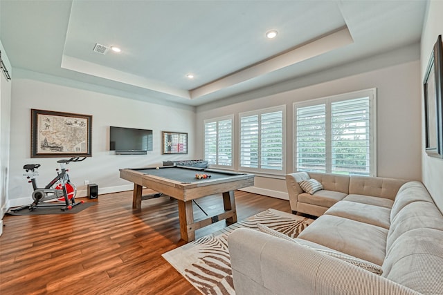 recreation room with a raised ceiling, visible vents, and dark wood finished floors