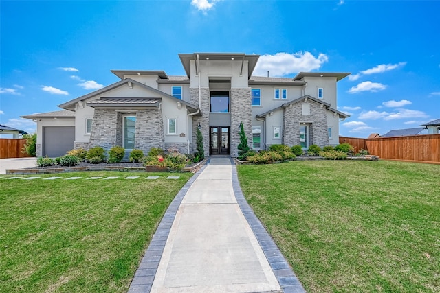 prairie-style house featuring an attached garage, fence, a front lawn, and stucco siding