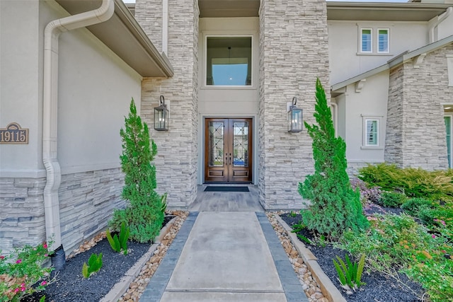 property entrance with french doors and stucco siding