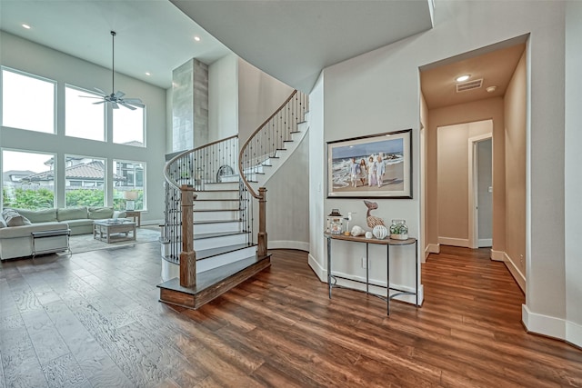 stairs featuring recessed lighting, wood finished floors, a ceiling fan, visible vents, and baseboards