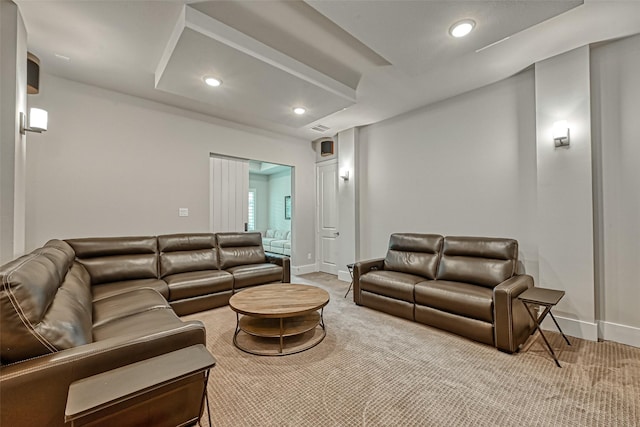 carpeted living room featuring baseboards and recessed lighting