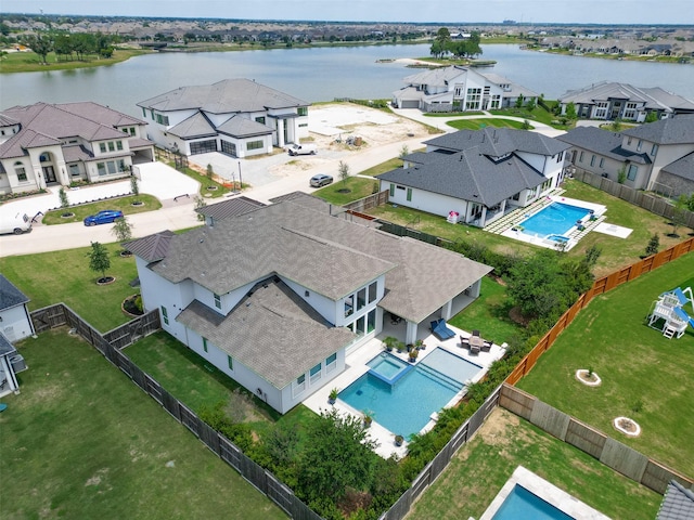 birds eye view of property with a water view and a residential view