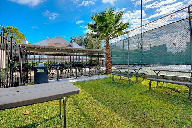 view of property's community with a yard and fence