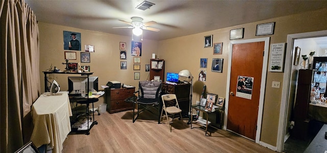 home office featuring ceiling fan, wood finished floors, and visible vents