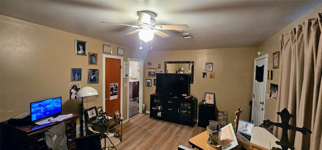 office area featuring light wood-style flooring, visible vents, and a ceiling fan