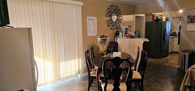 dining space with dark tile patterned flooring