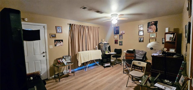 office area with visible vents, baseboards, a ceiling fan, and light wood-style floors