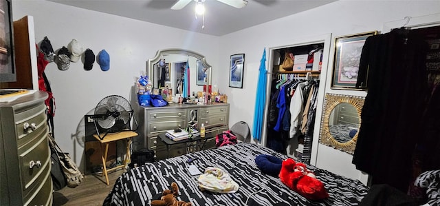 bedroom with ceiling fan, a closet, and wood finished floors