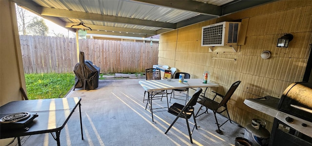 view of patio with fence and outdoor dining area