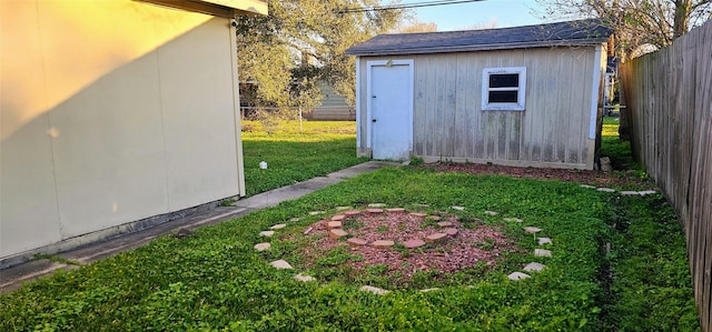 view of outdoor structure featuring an outbuilding and a fenced backyard