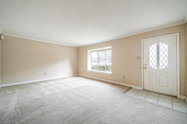 carpeted entryway with a textured ceiling, baseboards, tile patterned flooring, and crown molding