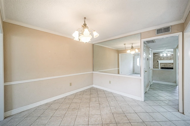 unfurnished room with a large fireplace, visible vents, ornamental molding, a textured ceiling, and ceiling fan with notable chandelier