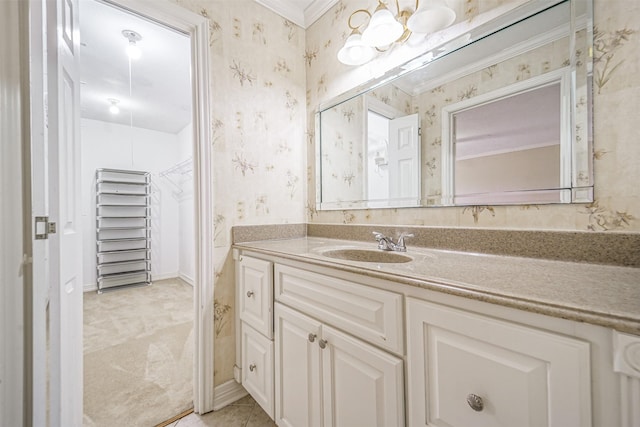 bathroom with baseboards, tile patterned floors, vanity, and wallpapered walls