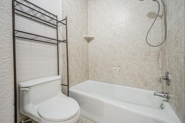 full bathroom featuring shower / bathtub combination, a textured wall, and toilet