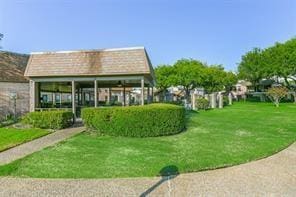 view of home's community with a yard