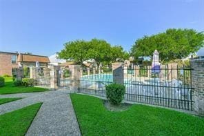 exterior space with fence and a lawn