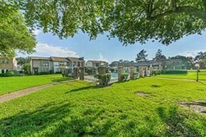 view of property's community with a lawn