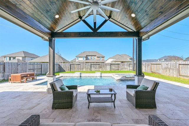 view of patio featuring a pool with connected hot tub, outdoor lounge area, a fenced backyard, and a gazebo