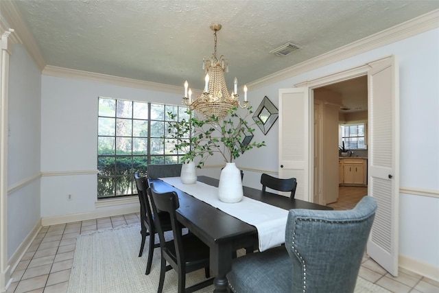 dining room featuring a textured ceiling, light tile patterned floors, visible vents, and crown molding