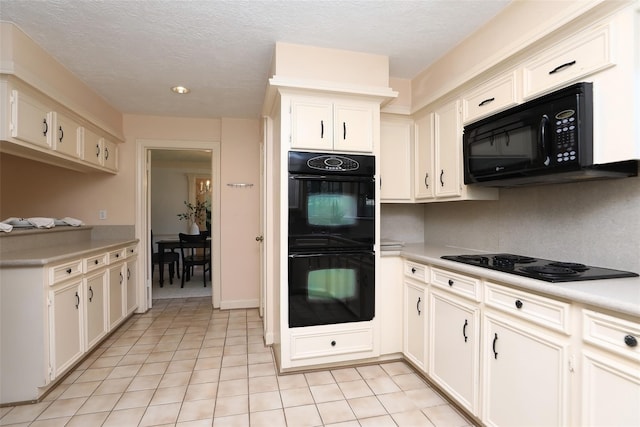 kitchen featuring light countertops, a textured ceiling, black appliances, and light tile patterned floors