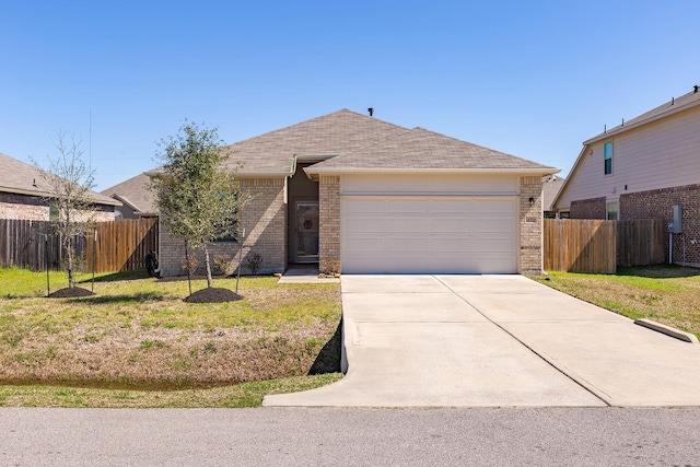 ranch-style home with an attached garage, brick siding, fence, driveway, and a front lawn