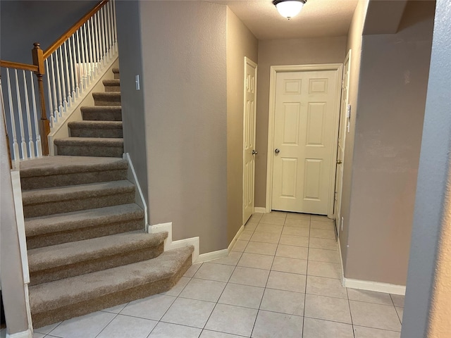 interior space with tile patterned flooring and baseboards