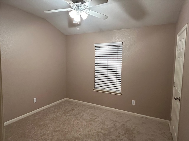 carpeted empty room with a ceiling fan and baseboards