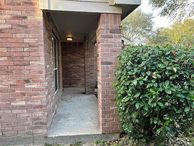 view of exterior entry with brick siding