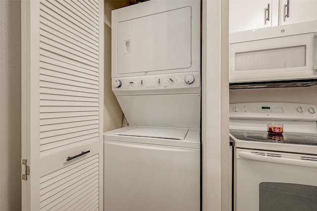 clothes washing area featuring laundry area and stacked washing maching and dryer