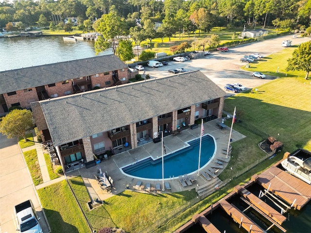 view of pool with a water view and a dock