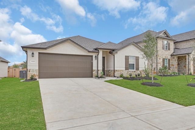 view of front of home with a garage, stone siding, a front lawn, and cooling unit