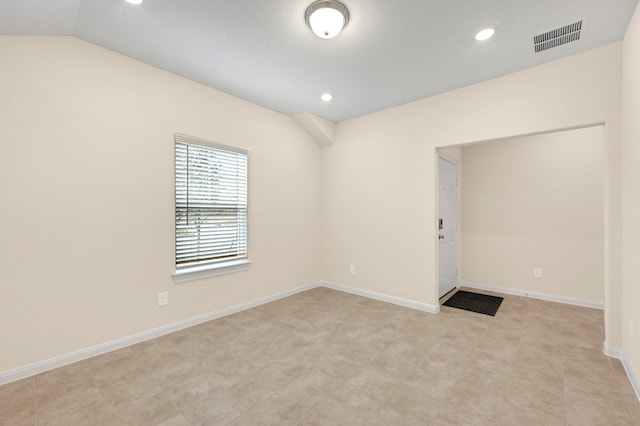 spare room with vaulted ceiling, recessed lighting, visible vents, and baseboards