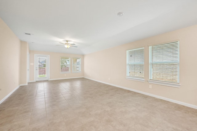 unfurnished room featuring a ceiling fan, visible vents, baseboards, and light tile patterned flooring