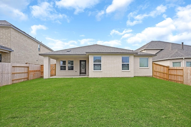 back of property with a patio area, a fenced backyard, a lawn, and brick siding