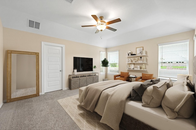 carpeted bedroom featuring visible vents and a ceiling fan