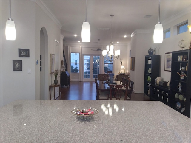 kitchen featuring arched walkways, french doors, visible vents, and crown molding