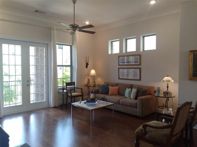 living area featuring ornamental molding, french doors, plenty of natural light, and wood finished floors