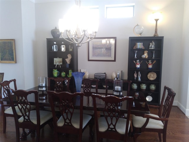 dining space with a chandelier and wood finished floors