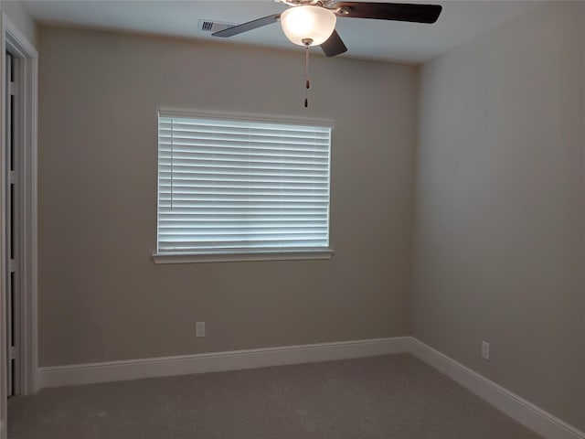 empty room featuring carpet, visible vents, baseboards, and a ceiling fan