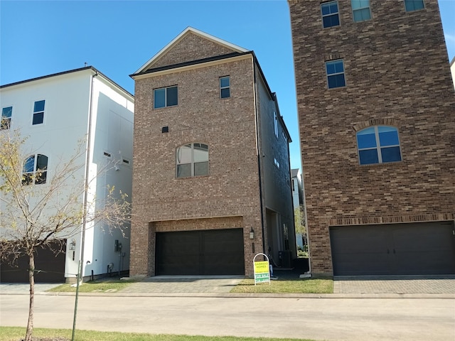 view of front facade with driveway, brick siding, and central air condition unit