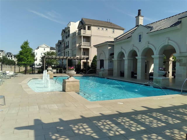 pool featuring a patio area and fence