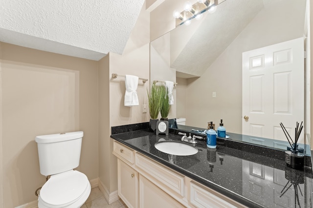 half bathroom featuring baseboards, toilet, tile patterned flooring, a textured ceiling, and vanity