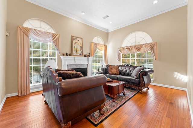 living area featuring ornamental molding, wood-type flooring, and baseboards