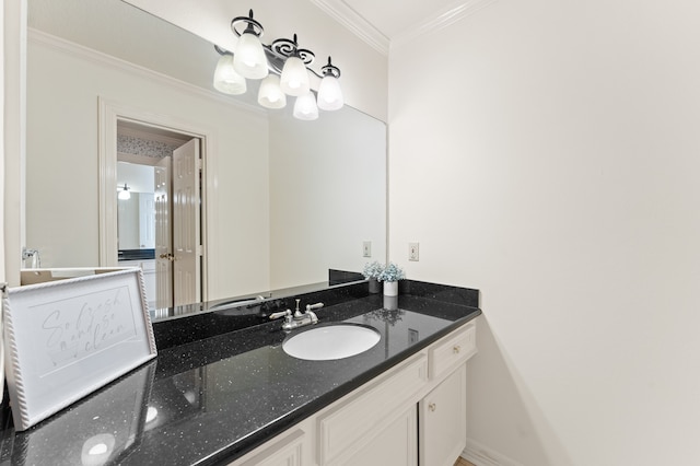 bathroom featuring ornamental molding, vanity, and baseboards