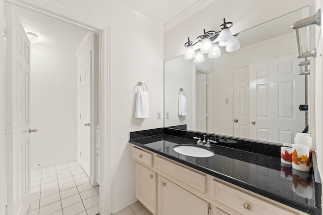 bathroom with baseboards, tile patterned flooring, vanity, and crown molding