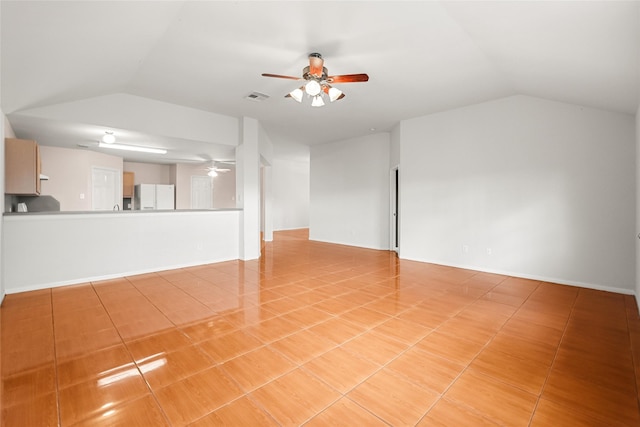 unfurnished living room featuring vaulted ceiling, light tile patterned floors, visible vents, and a ceiling fan