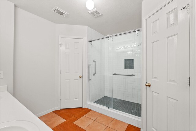 full bath featuring a stall shower, visible vents, and tile patterned floors