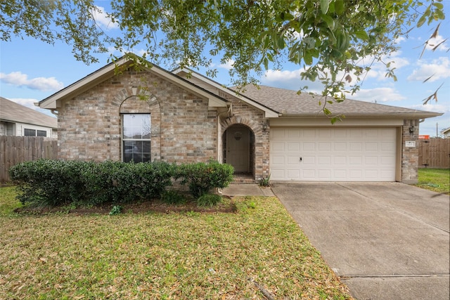 single story home featuring concrete driveway, an attached garage, fence, a front lawn, and brick siding