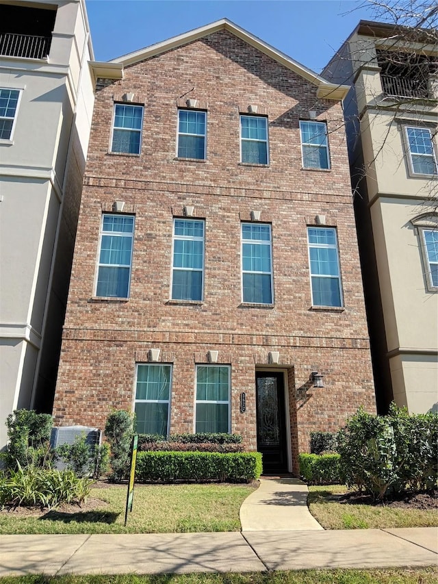 view of front of home featuring brick siding